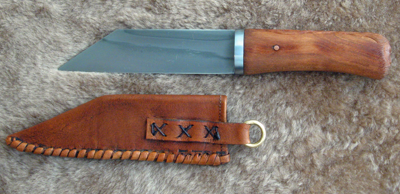 Differential quenched 1095 blade with egraved Turkish runes, steel bolster, hand carved Cherry Grip, antiqued leather scabbard.